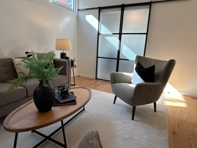 living room featuring light wood-type flooring and baseboards