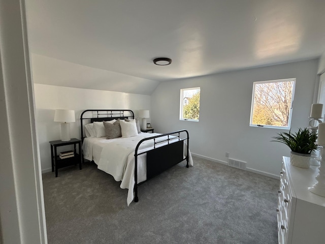 bedroom featuring carpet floors, visible vents, vaulted ceiling, and baseboards