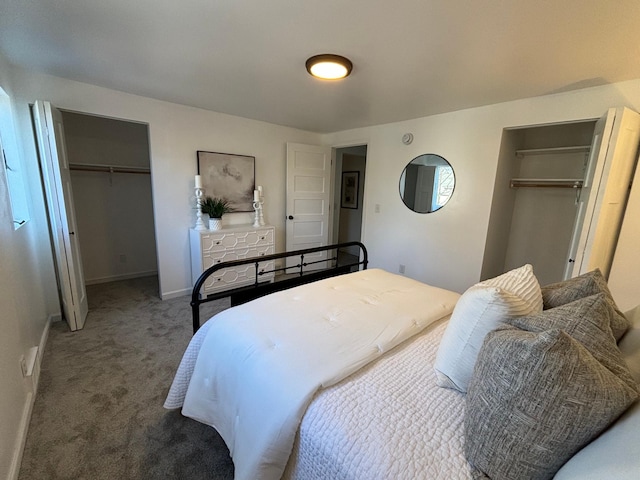 bedroom featuring baseboards, a walk in closet, a closet, and carpet flooring