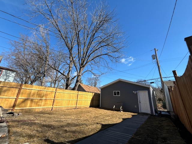 view of yard featuring an outbuilding and fence