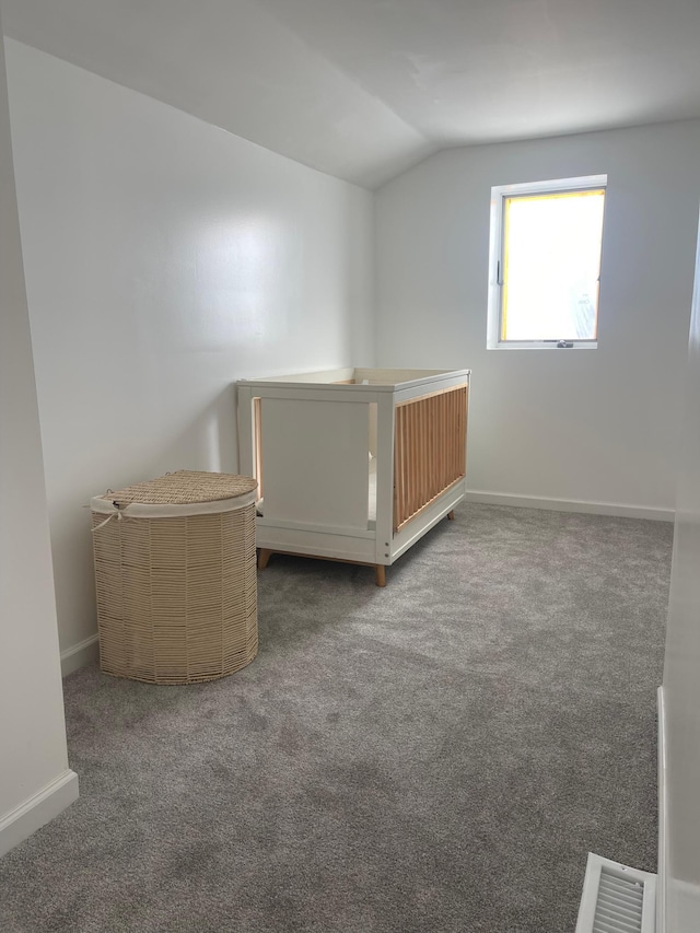 unfurnished bedroom featuring carpet floors, baseboards, and vaulted ceiling