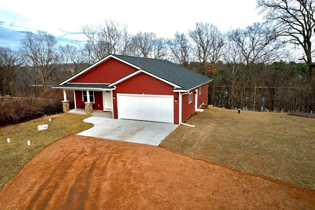 view of front of property featuring concrete driveway, a garage, a front yard, and roof with shingles