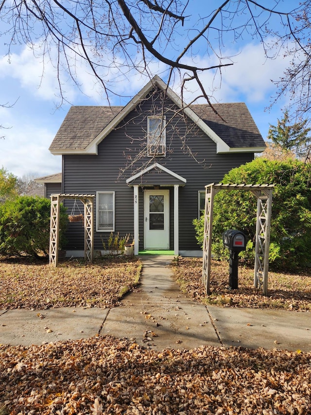 bungalow featuring roof with shingles