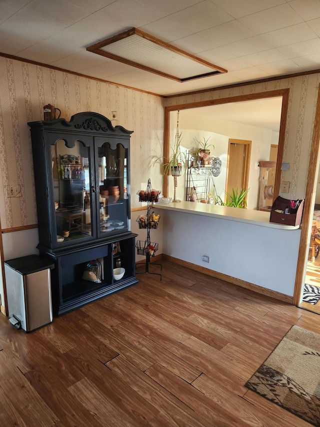 interior space featuring wood finished floors and wallpapered walls
