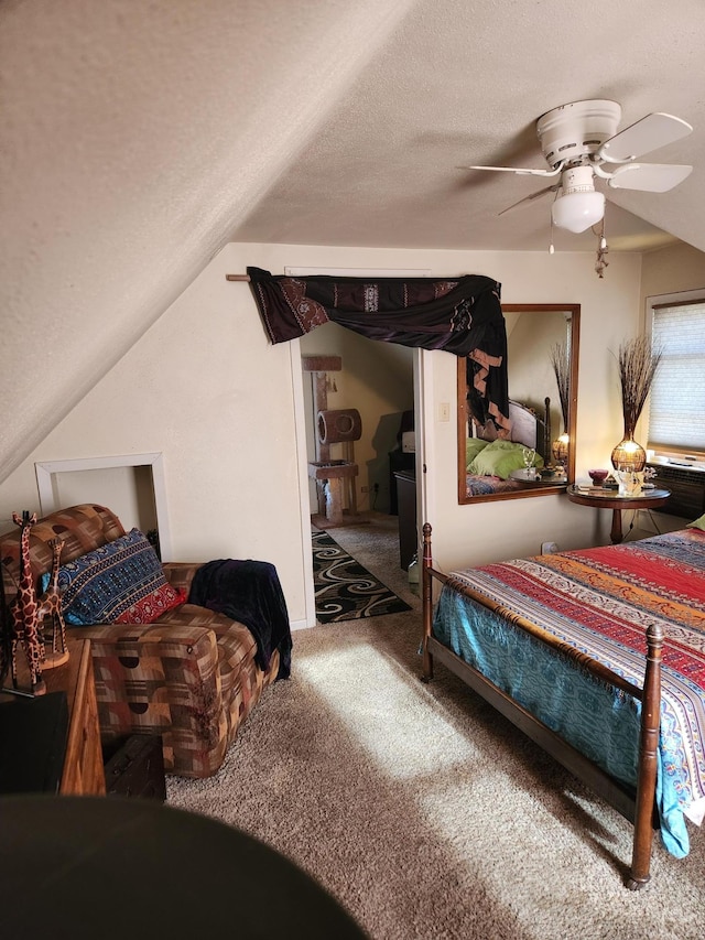 carpeted bedroom with lofted ceiling, a textured ceiling, and ceiling fan