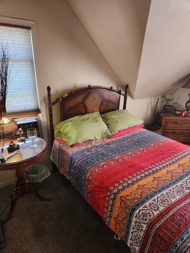 bedroom featuring carpet and vaulted ceiling