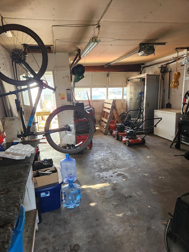 garage featuring refrigerator and a garage door opener