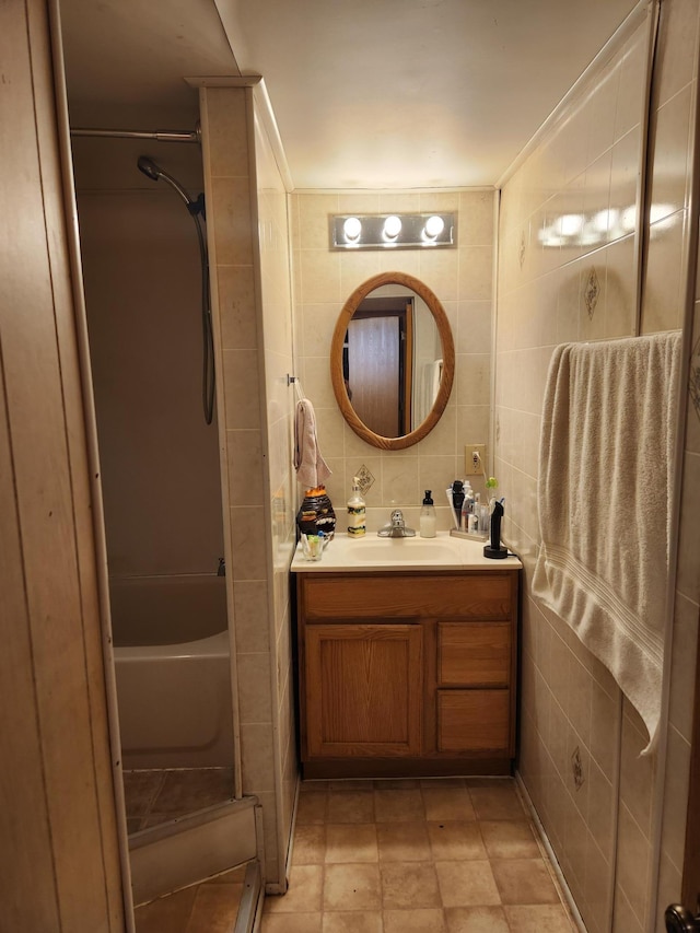 full bathroom with tile walls, bathtub / shower combination, and vanity