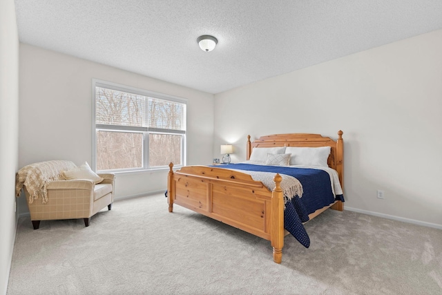 carpeted bedroom featuring baseboards and a textured ceiling