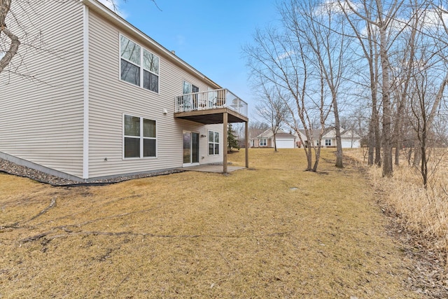 rear view of house with a yard and a patio