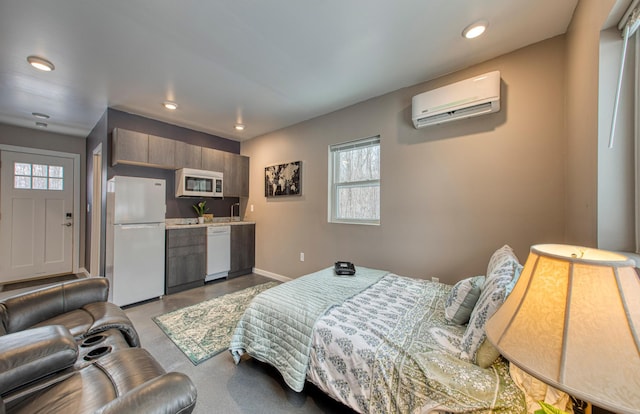 bedroom featuring baseboards, a wall mounted air conditioner, freestanding refrigerator, concrete flooring, and recessed lighting