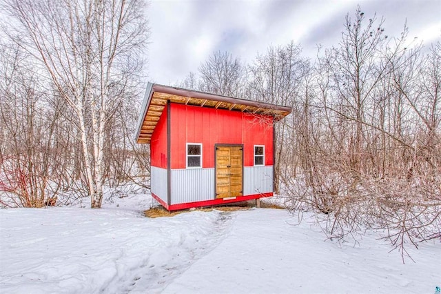 snow covered structure with an outdoor structure