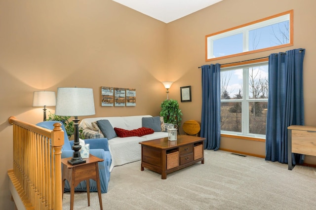 living room featuring carpet, visible vents, and baseboards