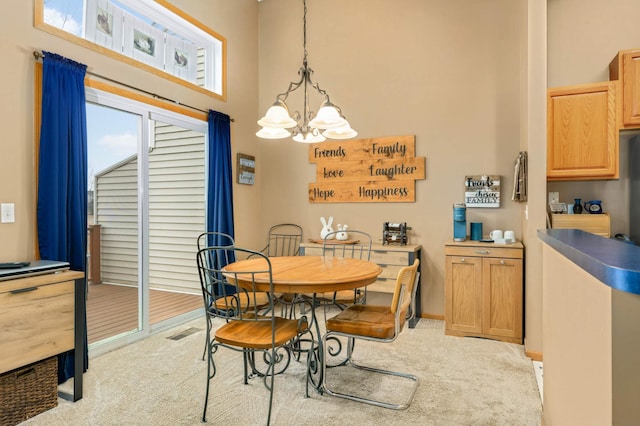 dining area featuring carpet, a towering ceiling, visible vents, and an inviting chandelier