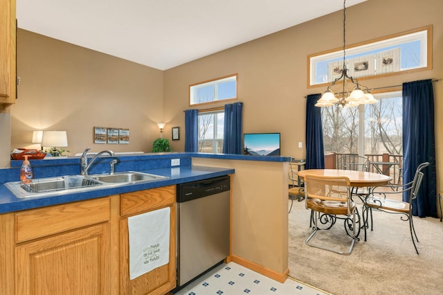 kitchen featuring a sink, hanging light fixtures, stainless steel dishwasher, dark countertops, and an inviting chandelier