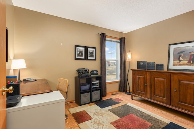 home office featuring light wood-style floors