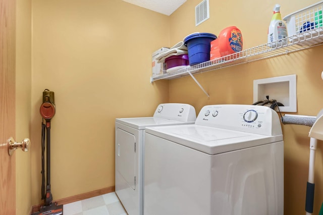 laundry area with light floors, visible vents, laundry area, independent washer and dryer, and baseboards