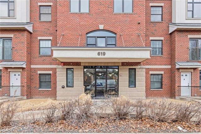 entrance to property with brick siding