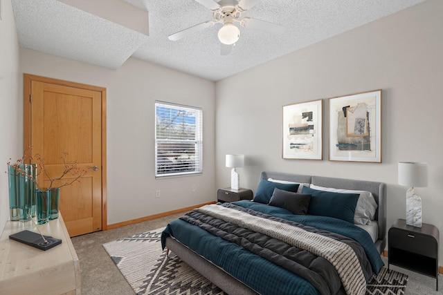 bedroom featuring light colored carpet, a textured ceiling, baseboards, and ceiling fan