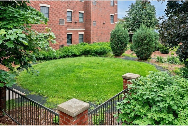 view of yard featuring fence and a wall mounted air conditioner