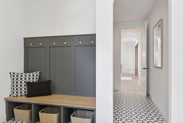 mudroom featuring baseboards and arched walkways