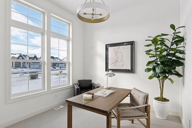 office featuring plenty of natural light, carpet, visible vents, and baseboards