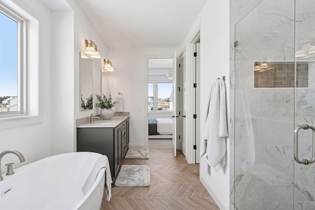 bathroom featuring a stall shower, ensuite bathroom, a soaking tub, and vanity