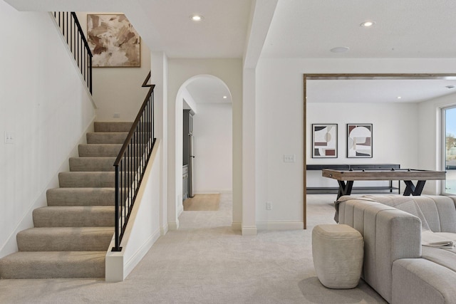 interior space featuring carpet, arched walkways, baseboards, and recessed lighting