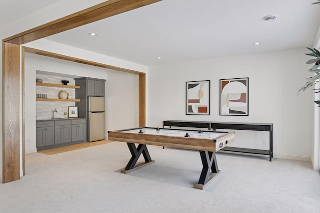 playroom with recessed lighting, light colored carpet, and a sink