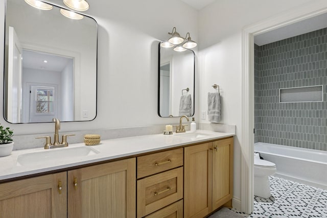 full bath featuring a sink, toilet, and double vanity