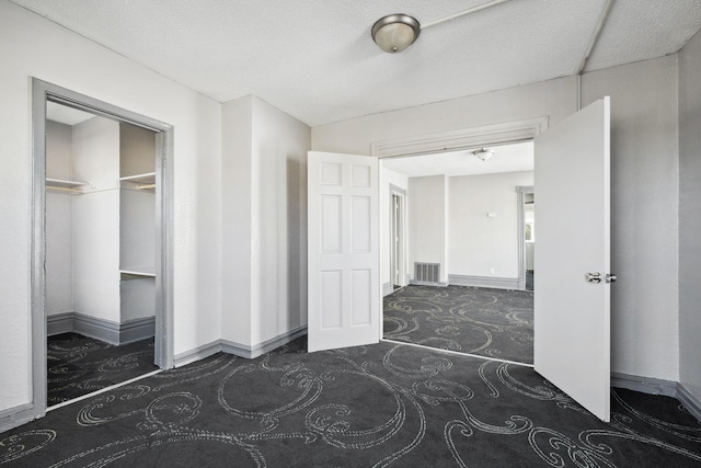 unfurnished bedroom with carpet floors, baseboards, and visible vents