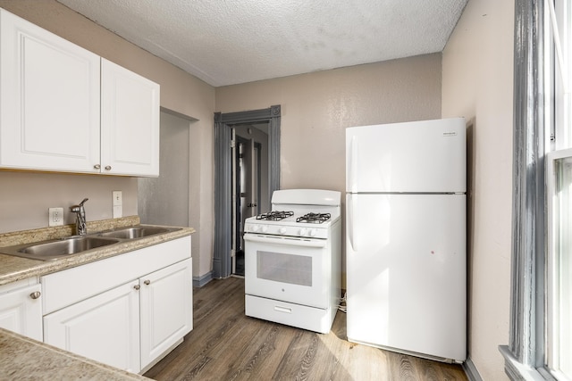 kitchen featuring white appliances, dark wood-style flooring, a textured ceiling, white cabinetry, and a sink