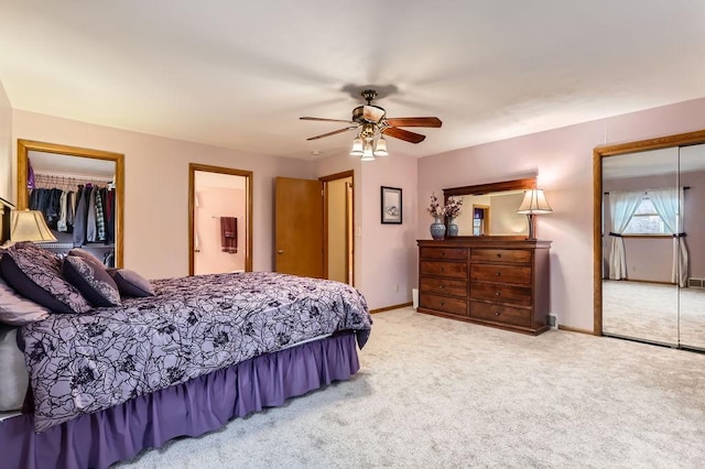 bedroom with a ceiling fan, a closet, carpet flooring, and baseboards