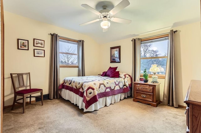 bedroom featuring a ceiling fan, light colored carpet, and baseboards