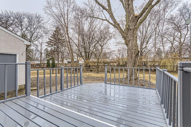 wooden deck with a fenced backyard