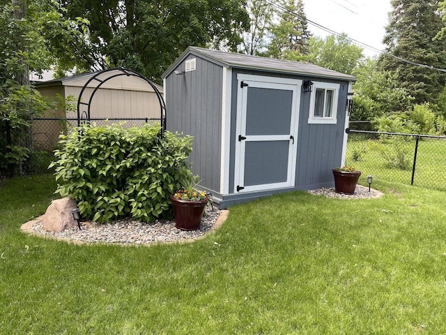 view of shed featuring fence