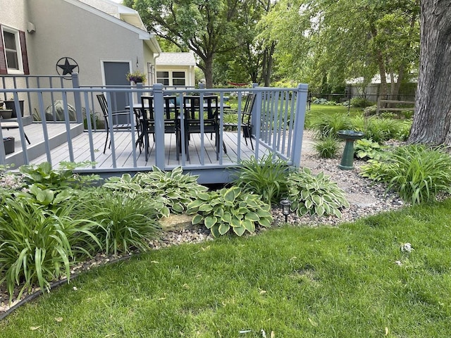 exterior space with outdoor dining space, a wooden deck, and fence