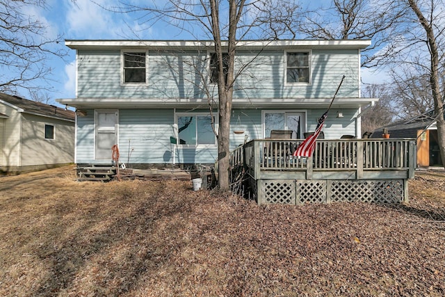 back of property featuring entry steps and a deck