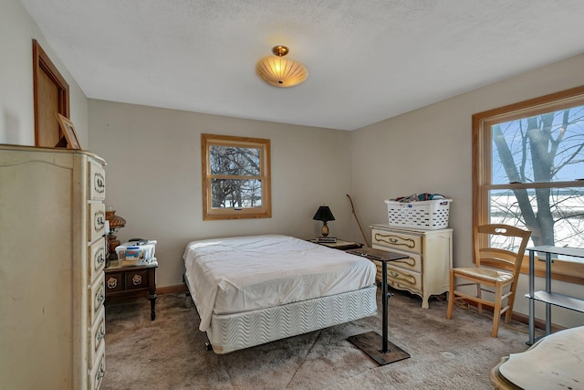 bedroom featuring baseboards and light carpet