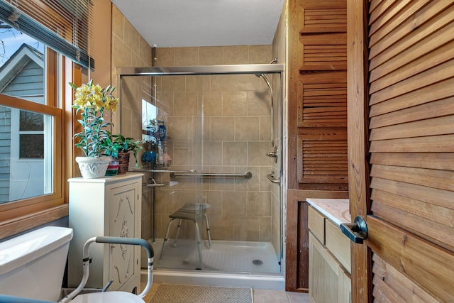 full bathroom featuring toilet and a shower stall