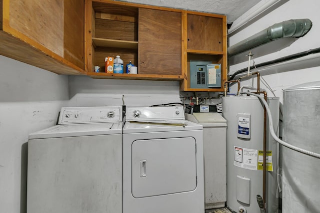 washroom with water heater, washing machine and dryer, cabinet space, and electric panel