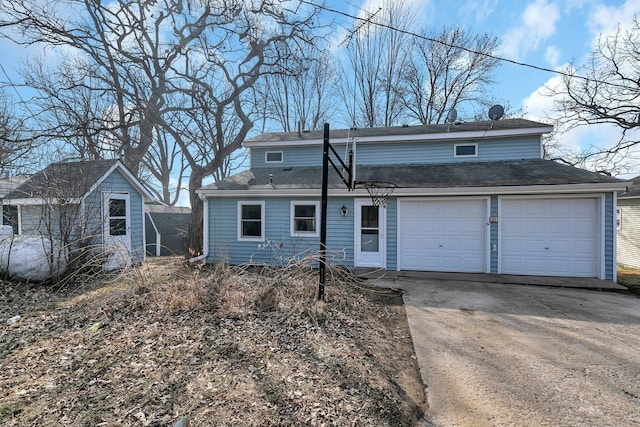 view of front facade featuring an attached garage, driveway, and a shingled roof