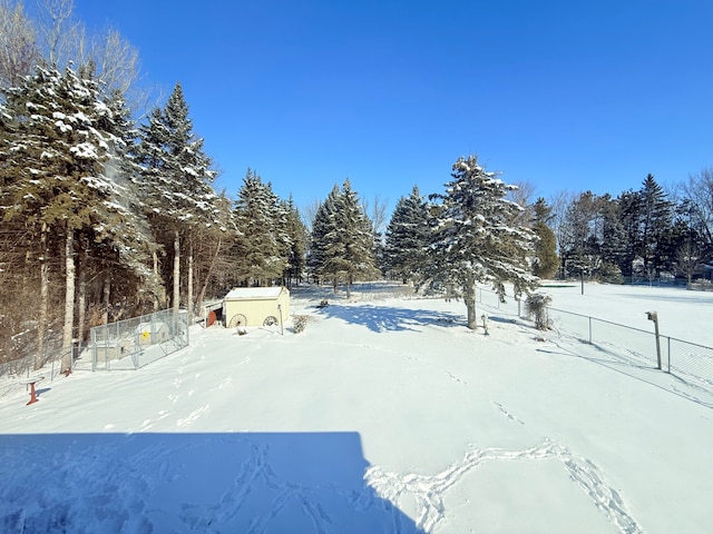 snowy yard with fence