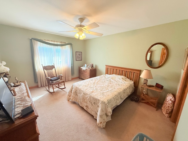 bedroom featuring a ceiling fan and light carpet