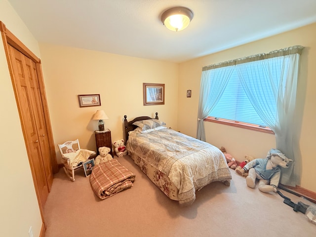 carpeted bedroom featuring a closet