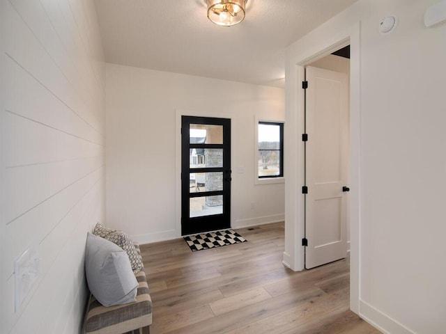 foyer featuring light wood-type flooring and baseboards