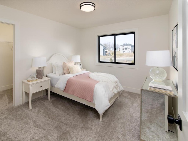 bedroom featuring carpet and baseboards