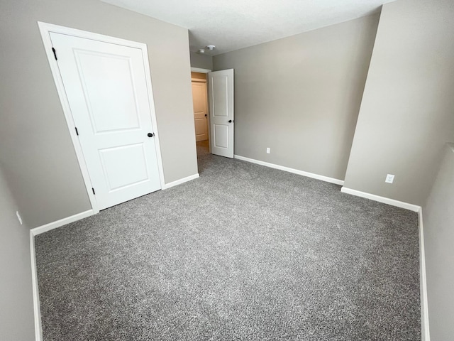 unfurnished bedroom featuring carpet and baseboards