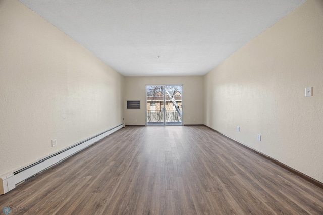 unfurnished room featuring a baseboard radiator, baseboards, visible vents, and wood finished floors