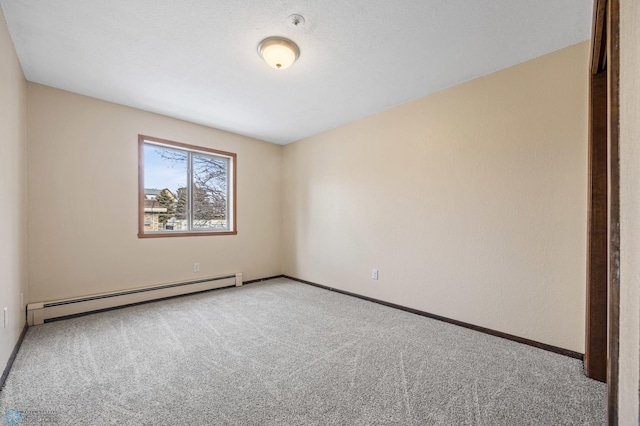 empty room with a baseboard radiator, baseboards, and carpet flooring